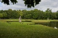 Schwerin, Germany - July 20, 2021 - The Castle Garden with statues and small bridges in the cloudy summer afternoon